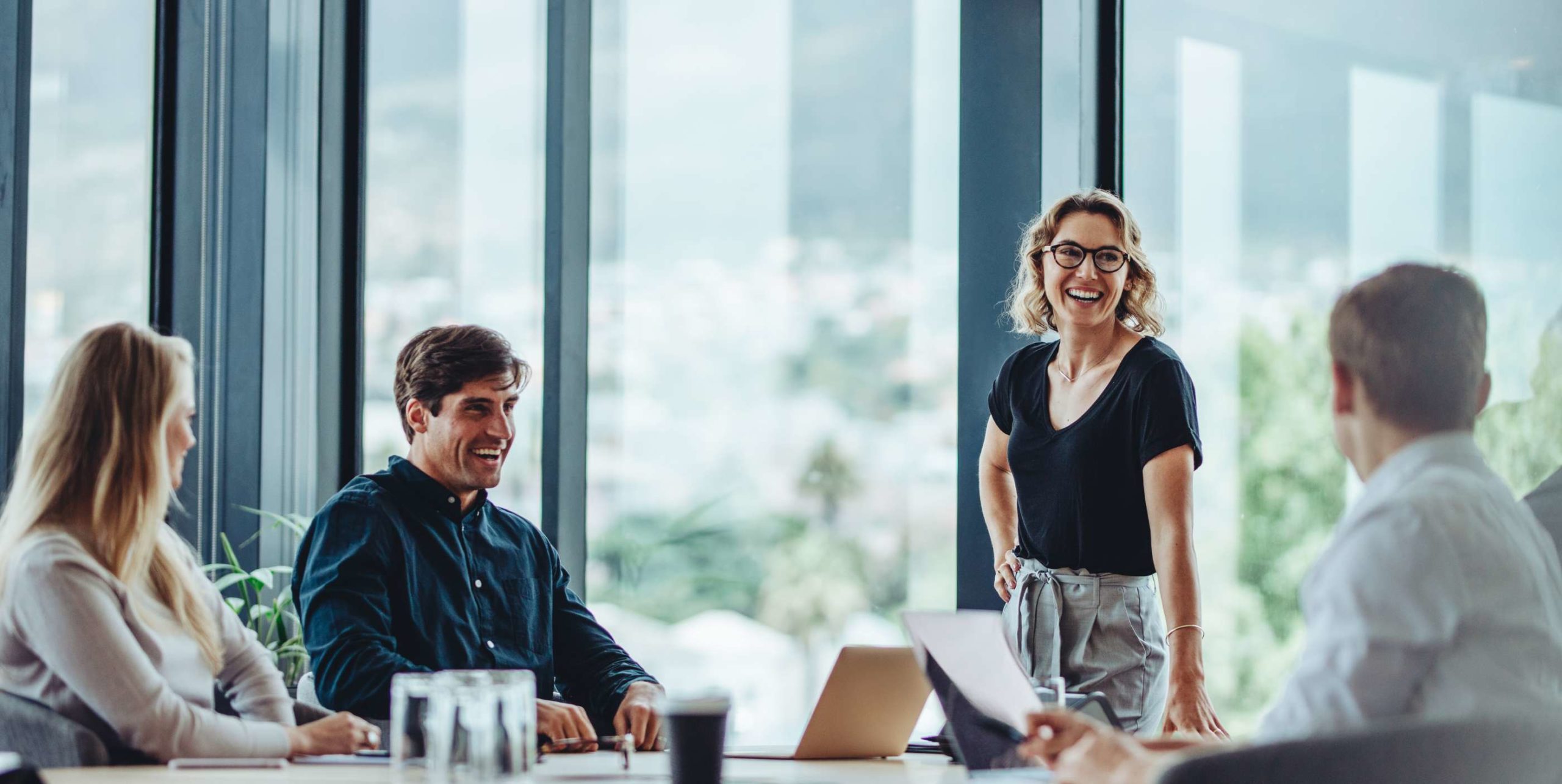 a happy work team laughing in a conference room