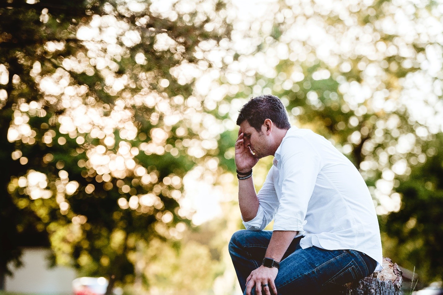 distressed man sitting in a park