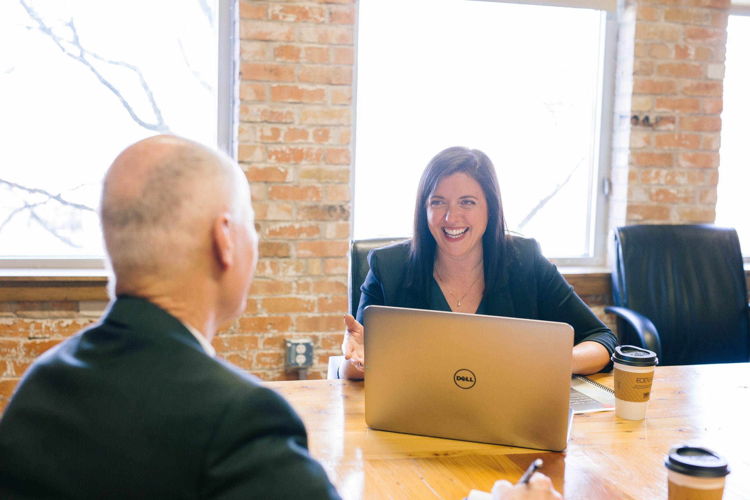 A lady giving presentation in a meeting