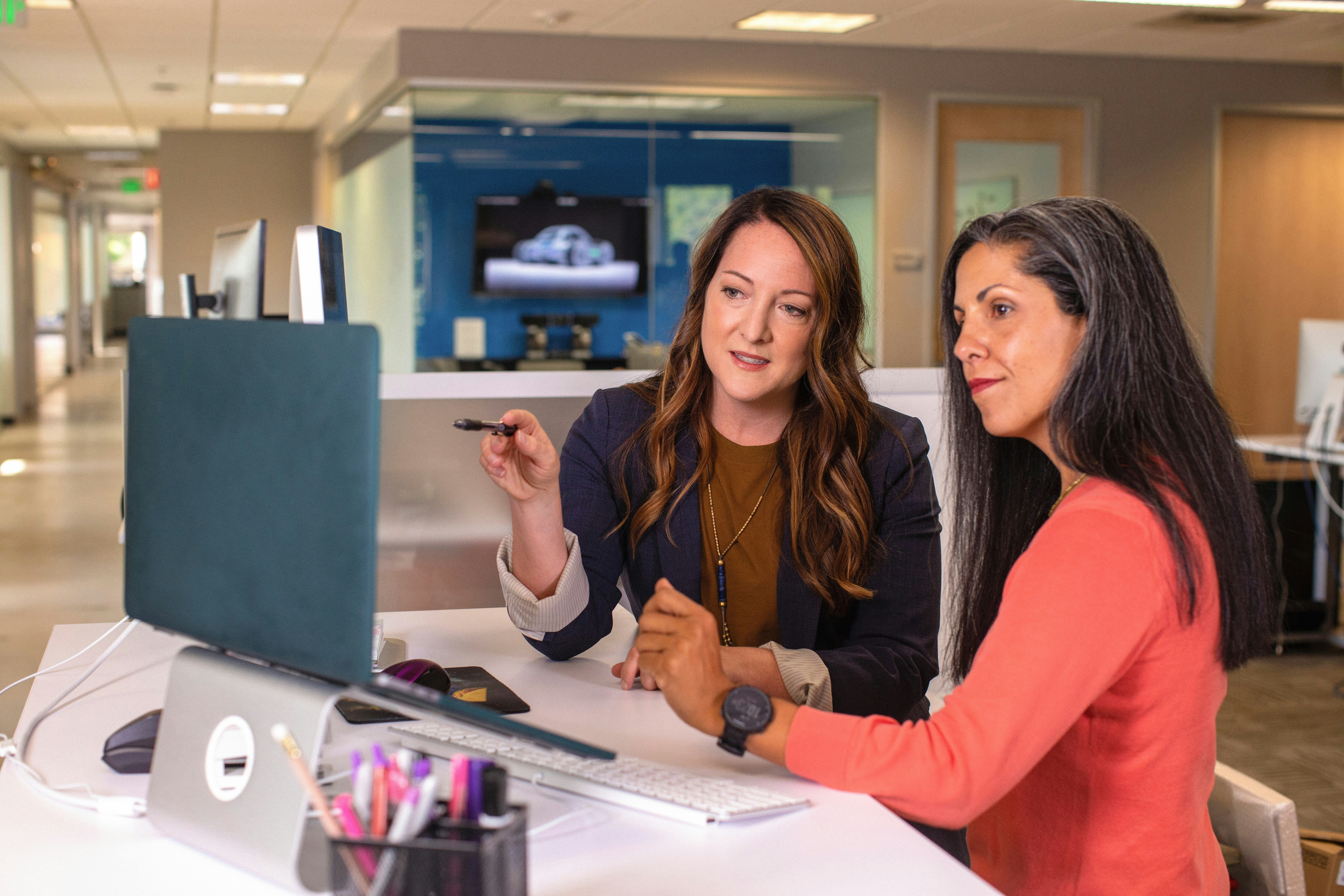 Professional Women Discussing Strategy A lady giving presentation in a meeting